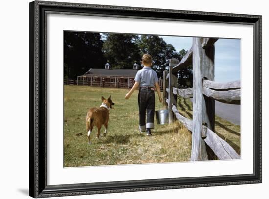 Boy and His Dog Walking Along a Fence-William P. Gottlieb-Framed Photographic Print