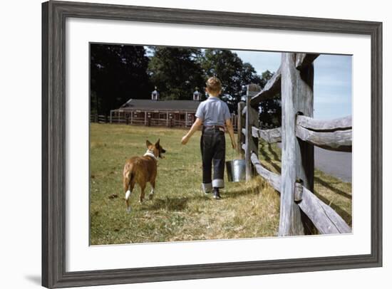 Boy and His Dog Walking Along a Fence-William P. Gottlieb-Framed Photographic Print