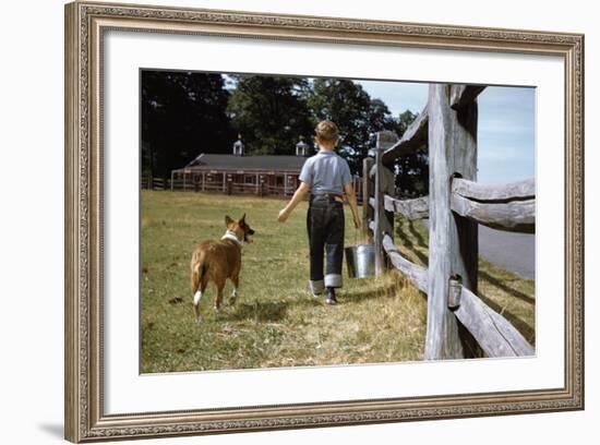 Boy and His Dog Walking Along a Fence-William P. Gottlieb-Framed Photographic Print