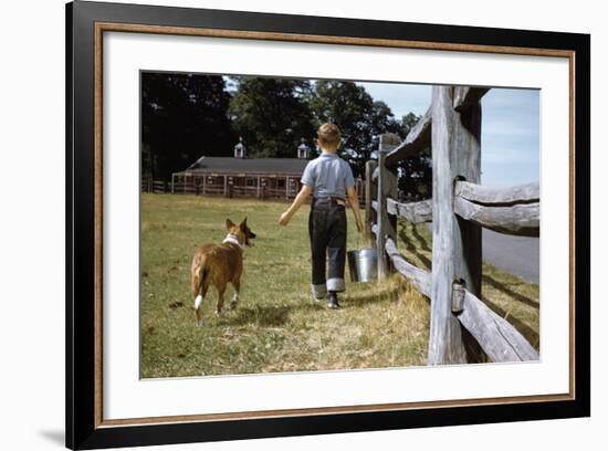 Boy and His Dog Walking Along a Fence-William P. Gottlieb-Framed Photographic Print