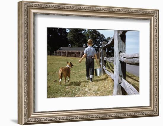 Boy and His Dog Walking Along a Fence-William P. Gottlieb-Framed Photographic Print