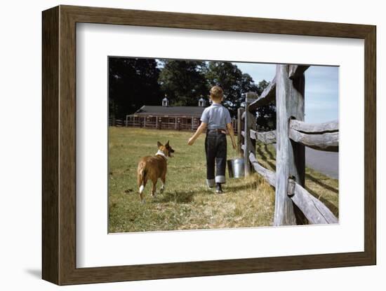 Boy and His Dog Walking Along a Fence-William P. Gottlieb-Framed Photographic Print