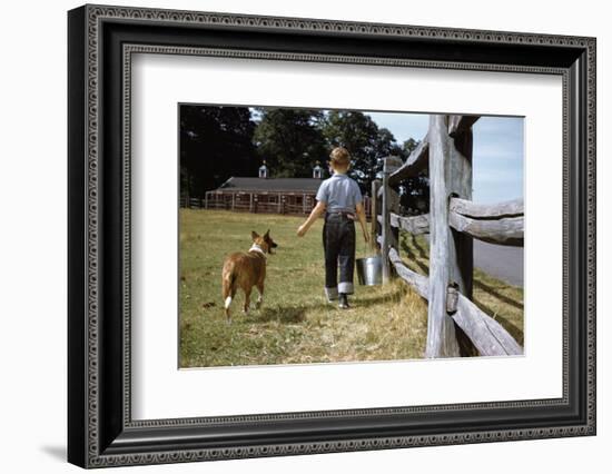 Boy and His Dog Walking Along a Fence-William P. Gottlieb-Framed Photographic Print