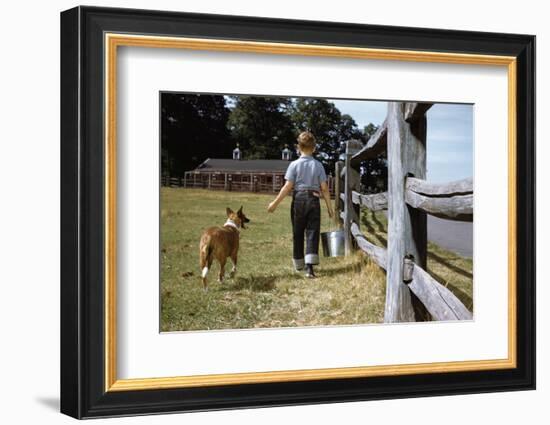 Boy and His Dog Walking Along a Fence-William P. Gottlieb-Framed Photographic Print