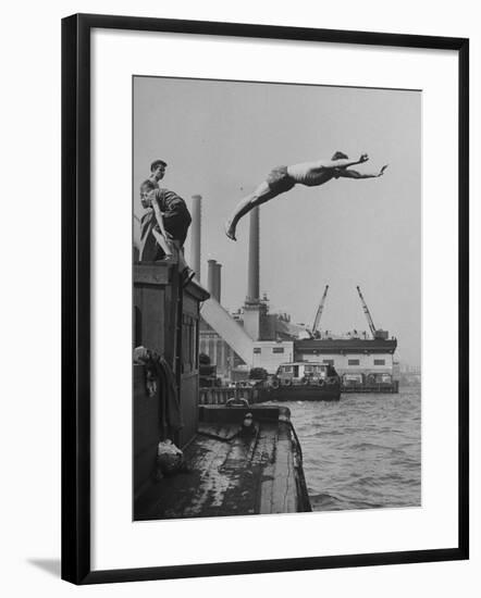 Boy Diving from Top of Building on Wharf, Poised in Air over River-null-Framed Photographic Print