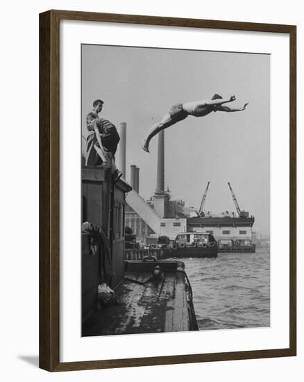Boy Diving from Top of Building on Wharf, Poised in Air over River-null-Framed Photographic Print