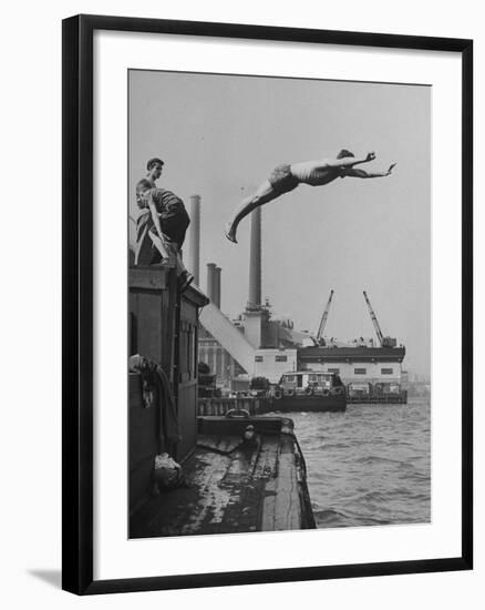 Boy Diving from Top of Building on Wharf, Poised in Air over River-null-Framed Photographic Print