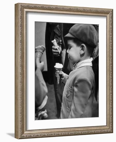 Boy Eating Ice Cream Cone at the Circus in Madison Square Garden-Cornell Capa-Framed Photographic Print