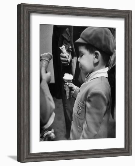 Boy Eating Ice Cream Cone at the Circus in Madison Square Garden-Cornell Capa-Framed Photographic Print