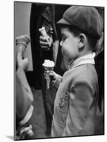 Boy Eating Ice Cream Cone at the Circus in Madison Square Garden-Cornell Capa-Mounted Photographic Print