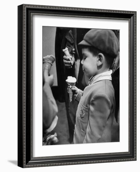 Boy Eating Ice Cream Cone at the Circus in Madison Square Garden-Cornell Capa-Framed Photographic Print