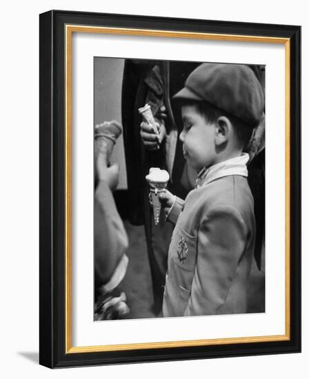 Boy Eating Ice Cream Cone at the Circus in Madison Square Garden-Cornell Capa-Framed Photographic Print