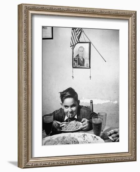 Boy Eating Spaghetti under Picture of His Brother Who Died During Invasion of Sicily-null-Framed Photographic Print