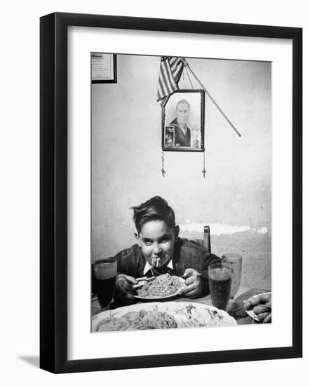 Boy Eating Spaghetti under Picture of His Brother Who Died During Invasion of Sicily-null-Framed Photographic Print