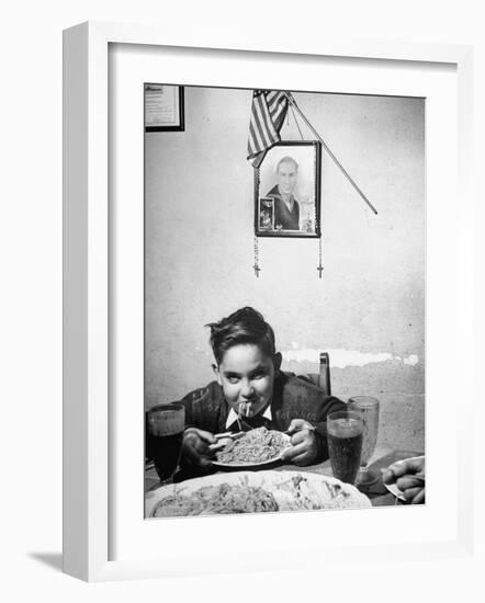 Boy Eating Spaghetti under Picture of His Brother Who Died During Invasion of Sicily-null-Framed Photographic Print