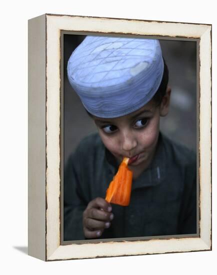 Boy Eats an Ice Lolly in a Neighborhood on the Outskirts of Islamabad, Pakistan-null-Framed Premier Image Canvas