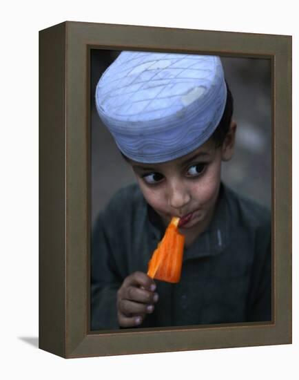 Boy Eats an Ice Lolly in a Neighborhood on the Outskirts of Islamabad, Pakistan-null-Framed Premier Image Canvas