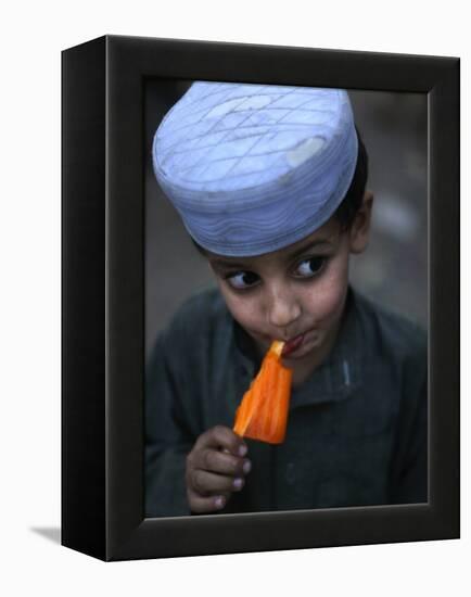 Boy Eats an Ice Lolly in a Neighborhood on the Outskirts of Islamabad, Pakistan-null-Framed Premier Image Canvas