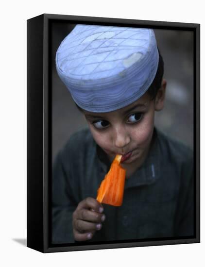 Boy Eats an Ice Lolly in a Neighborhood on the Outskirts of Islamabad, Pakistan-null-Framed Premier Image Canvas