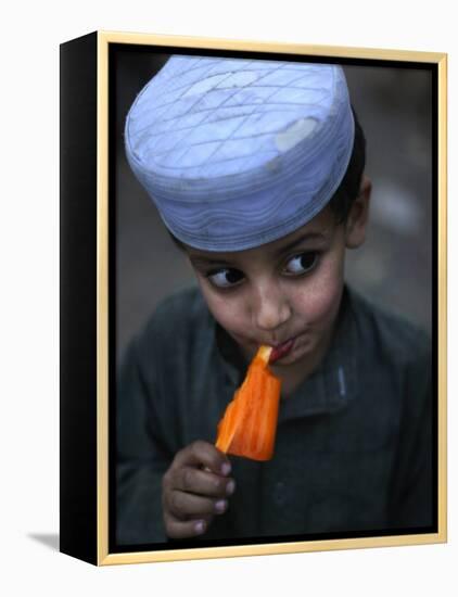Boy Eats an Ice Lolly in a Neighborhood on the Outskirts of Islamabad, Pakistan-null-Framed Premier Image Canvas