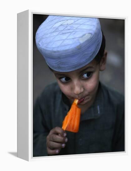 Boy Eats an Ice Lolly in a Neighborhood on the Outskirts of Islamabad, Pakistan-null-Framed Premier Image Canvas