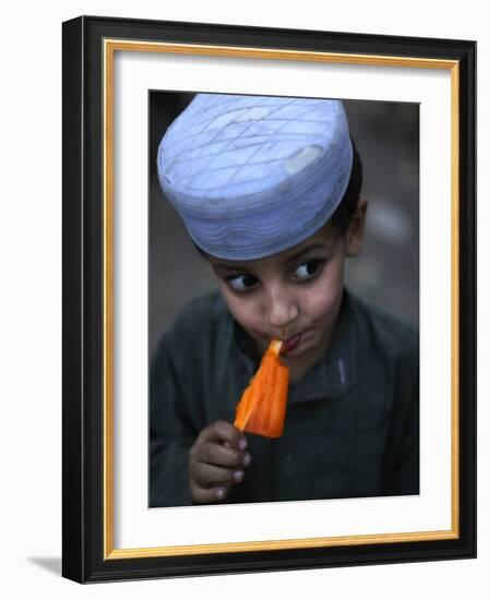 Boy Eats an Ice Lolly in a Neighborhood on the Outskirts of Islamabad, Pakistan-null-Framed Photographic Print