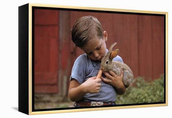 Boy Feeding a Rabbit-William P. Gottlieb-Framed Premier Image Canvas