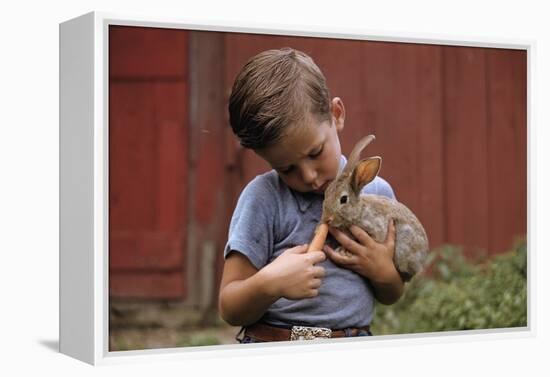 Boy Feeding a Rabbit-William P. Gottlieb-Framed Premier Image Canvas