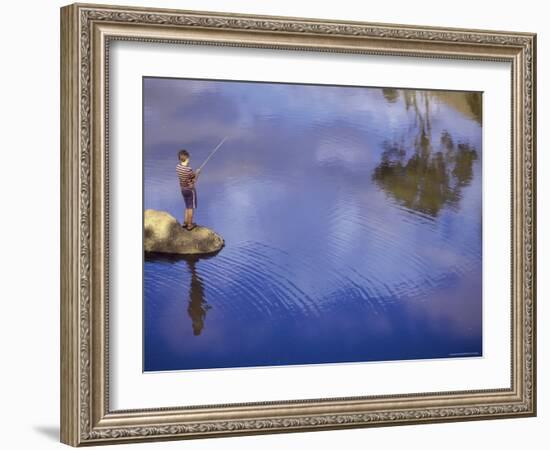 Boy Fishing from a Rock on a Pond-null-Framed Photographic Print