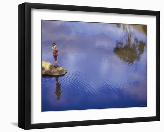 Boy Fishing from a Rock on a Pond-null-Framed Photographic Print