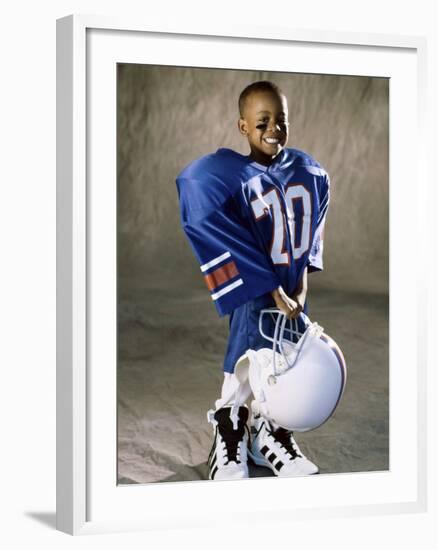 Boy in an Oversized Football Uniform Holding a Helmet-null-Framed Photographic Print