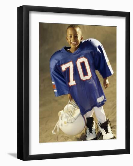 Boy in an Oversized Football Uniform Holding a Helmet-null-Framed Photographic Print