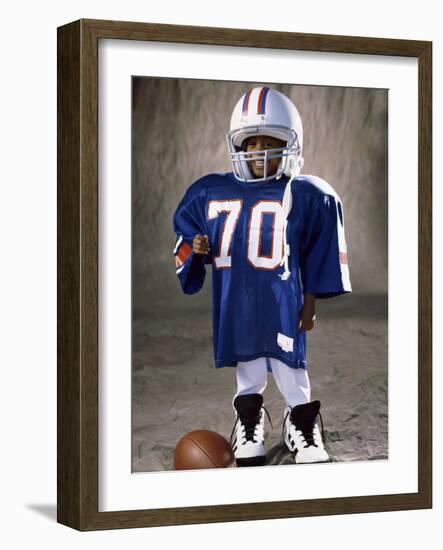 Boy in an Oversized Football Uniform Wearing a Helmet-null-Framed Photographic Print