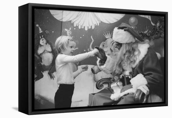 Boy Kissing African American Santa Claus in Unidentified Department Store. 1970-Ralph Morse-Framed Premier Image Canvas