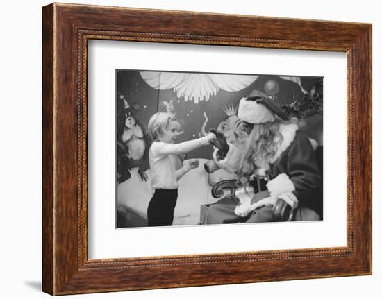 Boy Kissing African American Santa Claus in Unidentified Department Store. 1970-Ralph Morse-Framed Photographic Print