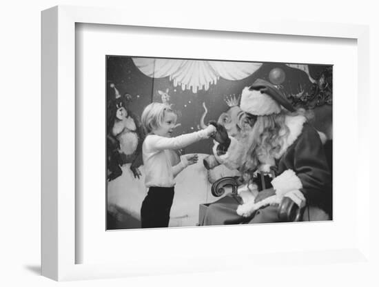 Boy Kissing African American Santa Claus in Unidentified Department Store. 1970-Ralph Morse-Framed Photographic Print