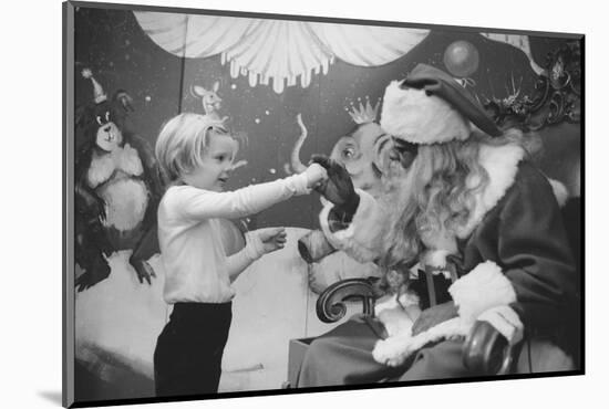 Boy Kissing African American Santa Claus in Unidentified Department Store. 1970-Ralph Morse-Mounted Photographic Print