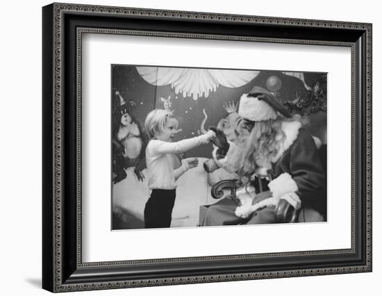 Boy Kissing African American Santa Claus in Unidentified Department Store. 1970-Ralph Morse-Framed Photographic Print