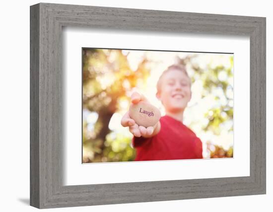 Boy Laughing and Holding a Stone with the Word Laugh. Instagram Effect-soupstock-Framed Photographic Print