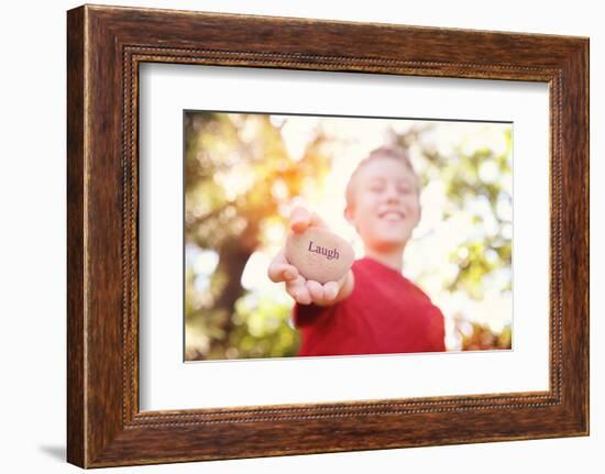 Boy Laughing and Holding a Stone with the Word Laugh. Instagram Effect-soupstock-Framed Photographic Print