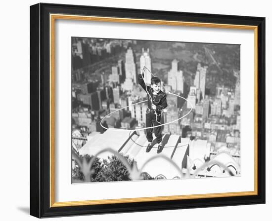 Boy on Ledge Twirling a Lasso-null-Framed Photographic Print