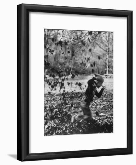 Boy Playing in a Pile of Autumn Leaves-Allan Grant-Framed Photographic Print