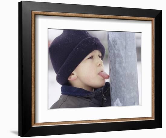 Boy Putting Tongue to Frozen Pole-Dann Tardif-Framed Photographic Print