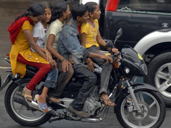 Boy Rides A Motorbike With Four Girls As It Drizzles In