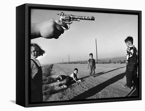 Boy's Hand Holding a Toy Six Shooter Pistol During a Game of "Cops and Robbers"-Howard Sochurek-Framed Premier Image Canvas