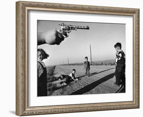 Boy's Hand Holding a Toy Six Shooter Pistol During a Game of "Cops and Robbers"-Howard Sochurek-Framed Photographic Print