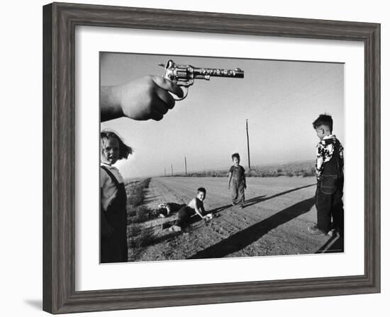 Boy's Hand Holding a Toy Six Shooter Pistol During a Game of "Cops and Robbers"-Howard Sochurek-Framed Photographic Print