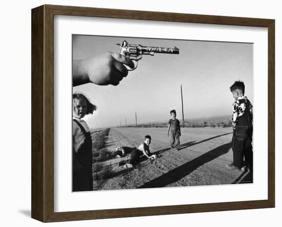 Boy's Hand Holding a Toy Six Shooter Pistol During a Game of "Cops and Robbers"-Howard Sochurek-Framed Photographic Print