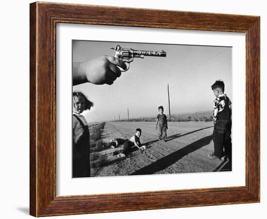 Boy's Hand Holding a Toy Six Shooter Pistol During a Game of "Cops and Robbers"-Howard Sochurek-Framed Photographic Print