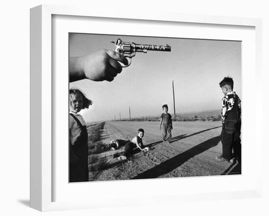 Boy's Hand Holding a Toy Six Shooter Pistol During a Game of "Cops and Robbers"-Howard Sochurek-Framed Photographic Print